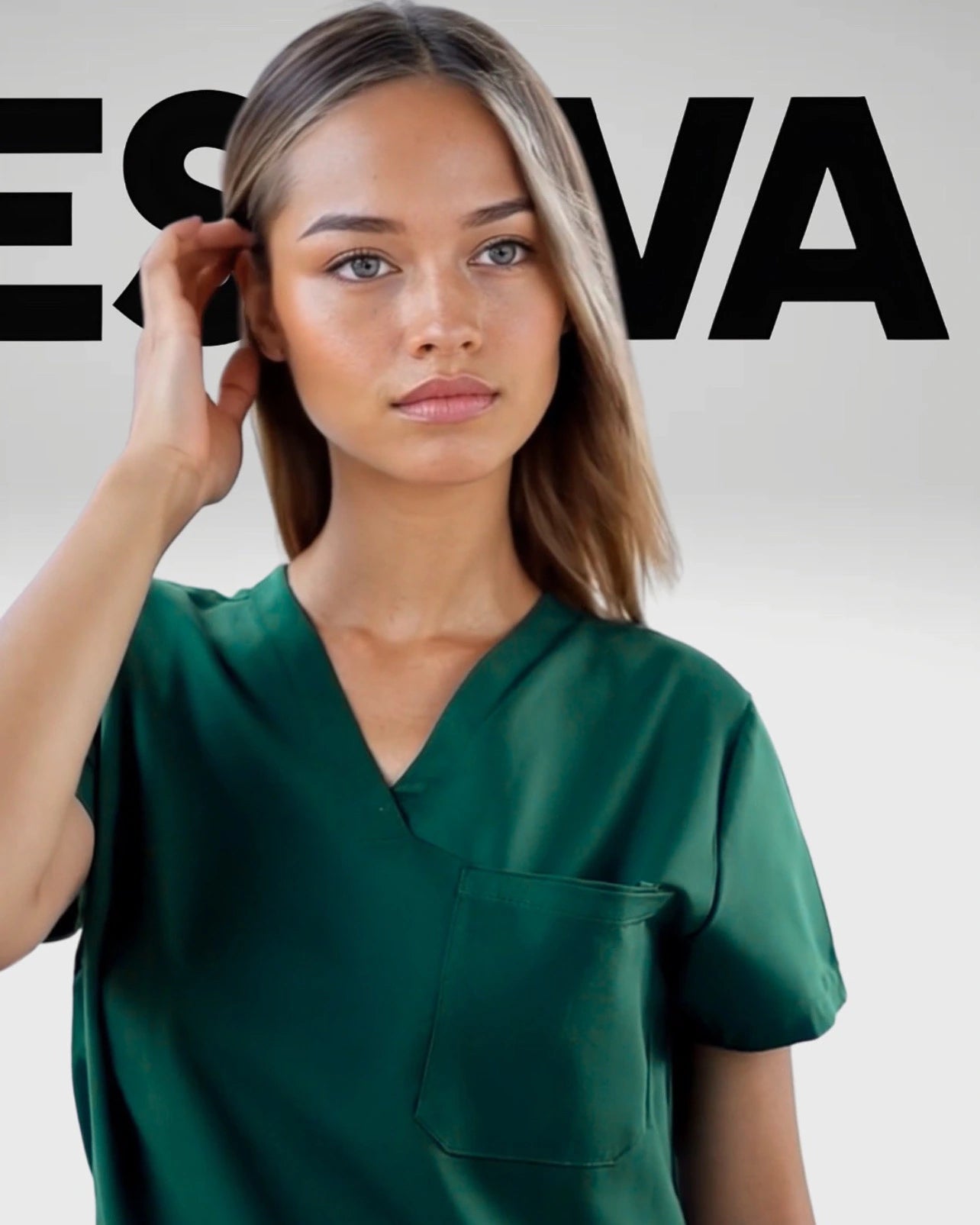 Woman wearing Estiva luxury green medical scrub top designed in Arizona
