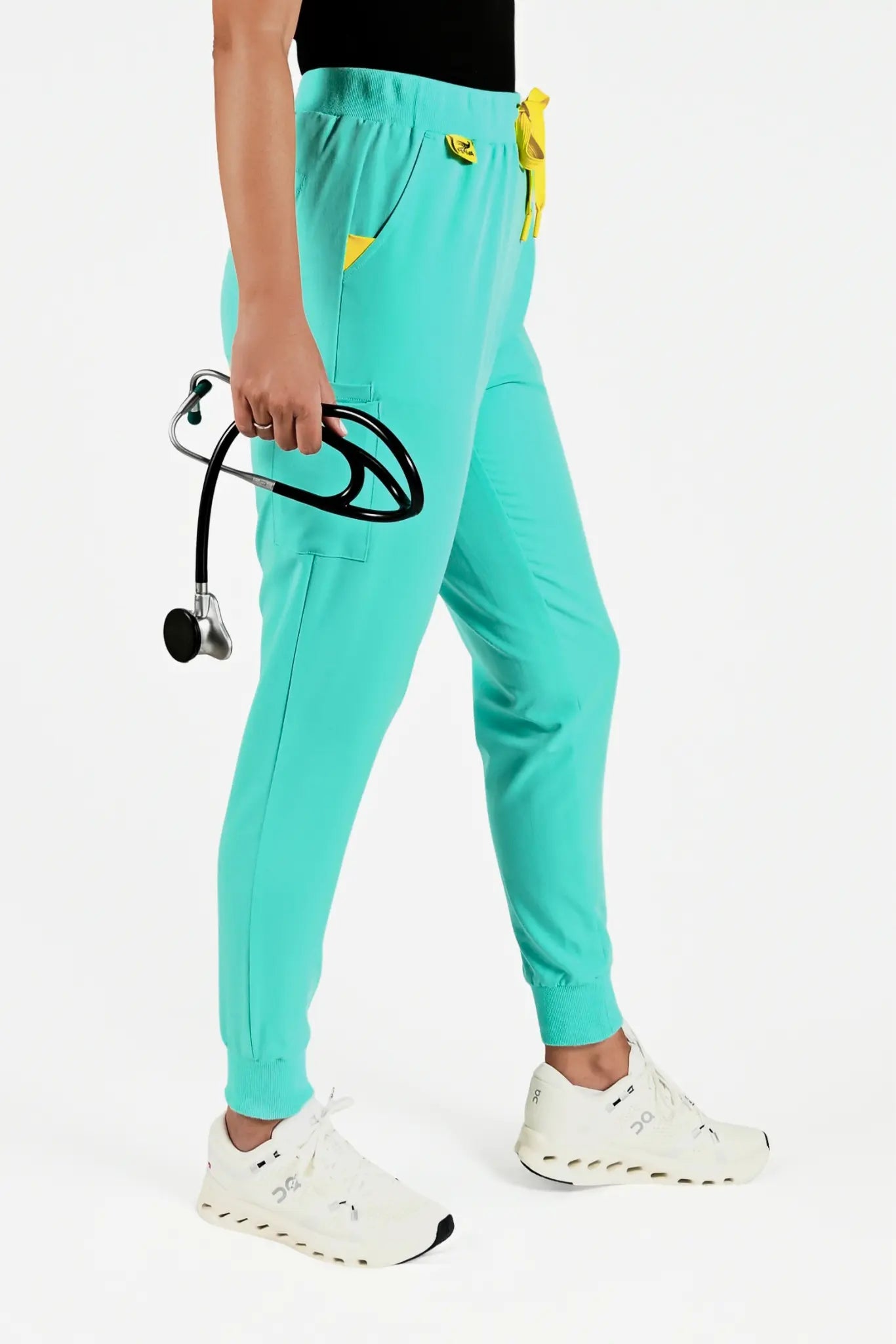 Estiva light turquoise medical scrub pants worn by healthcare professional with stethoscope