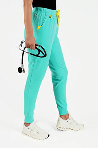 Estiva light turquoise medical scrub pants worn by healthcare professional with stethoscope
